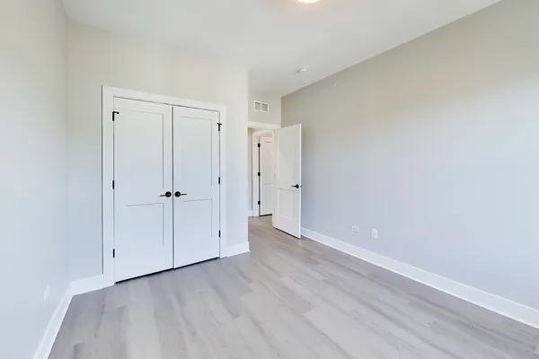 a view of an empty room with closet area