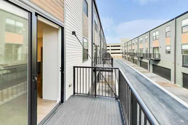 a view of balcony with floor to ceiling windows with wooden floor