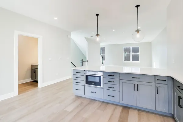 a spacious bedroom with a large bed and a chandelier