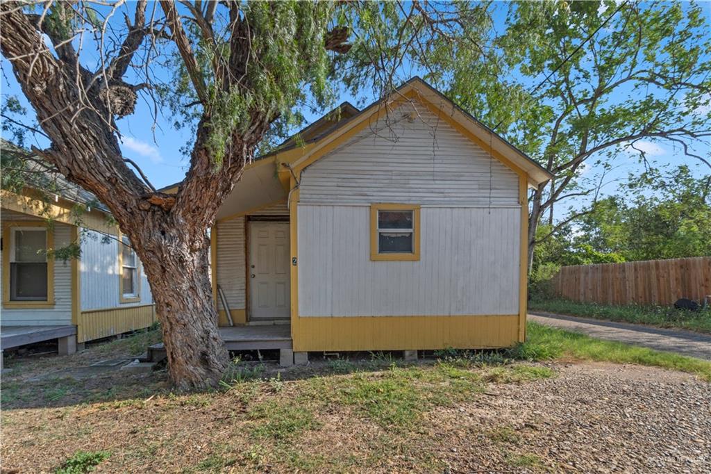 706 Doherty Avenue Mission, TX 78572 - Photo 5 of 21 a view of backyard with large tree and wooden fence