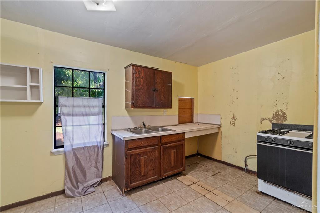 706 Doherty Avenue Mission, TX 78572 - Photo 8 of 21 a kitchen with a stove and a sink