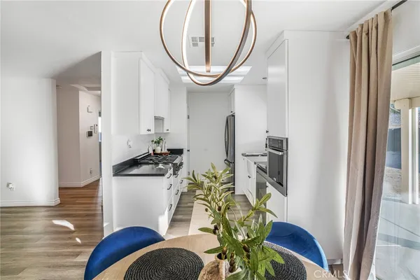 a dining room with furniture a rug and wooden floor