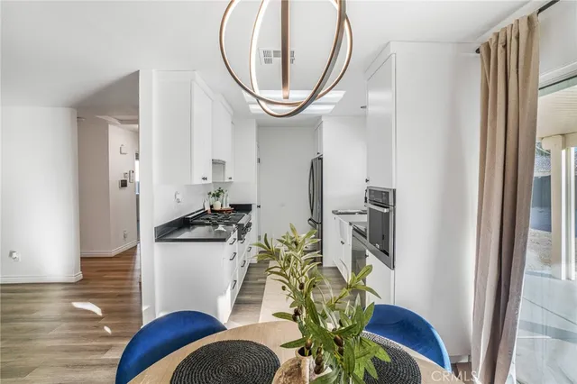 a dining room with furniture a rug and wooden floor