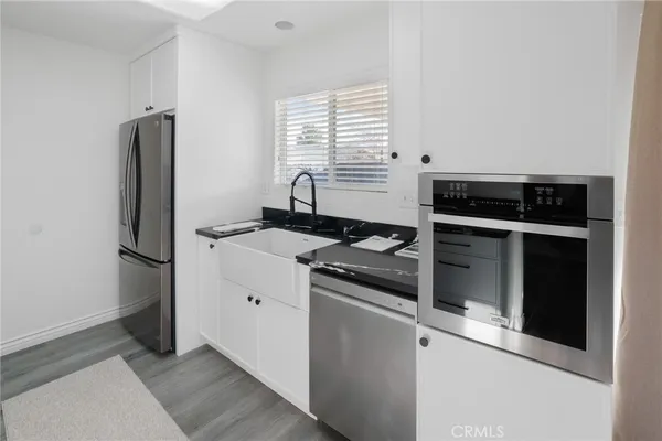 a kitchen with stainless steel appliances granite countertop a stove and a refrigerator