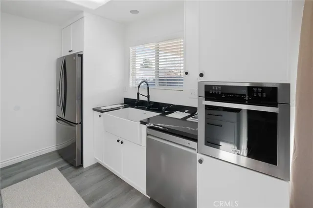 a kitchen with stainless steel appliances granite countertop a stove and a refrigerator