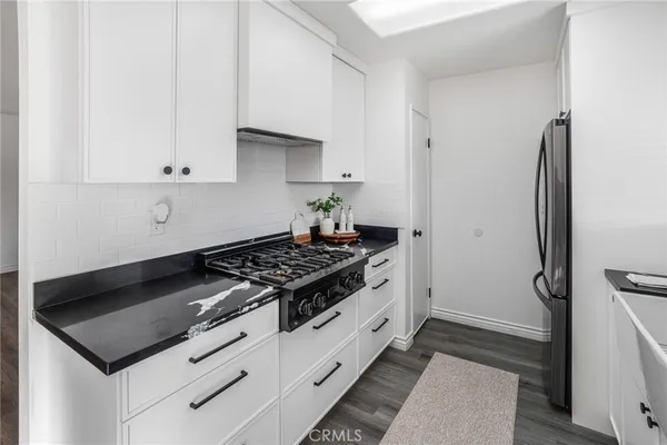 a stove top oven sitting inside of a kitchen