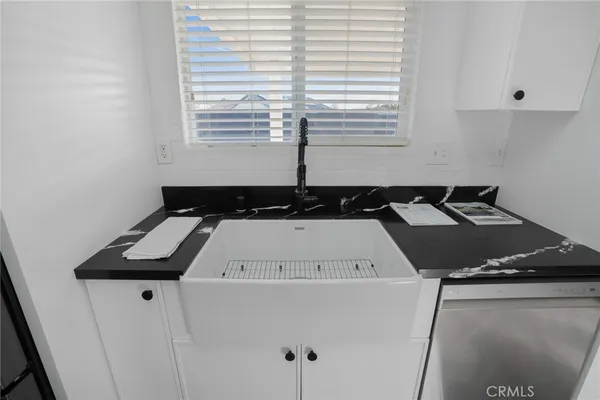 a close view of a stove a sink a microwave and cabinets