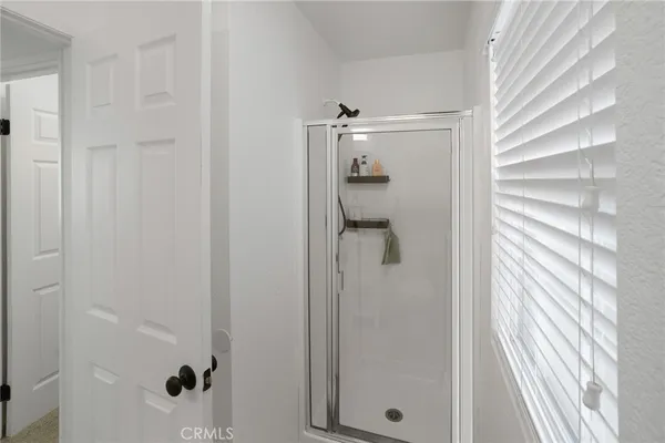 a bathroom with a glass shower door