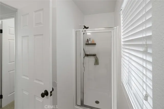 a bathroom with a glass shower door