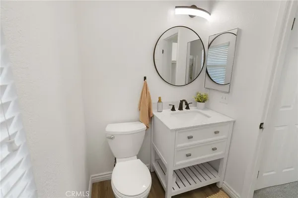 a bathroom with a toilet a sink and a mirror