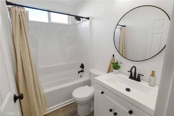 a bathroom with a sink toilet and a mirror