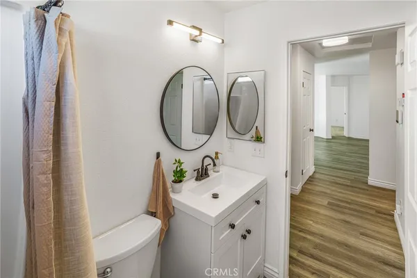 a bathroom with a sink mirror and toilet