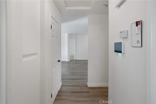 a view of a hallway with wooden floor and staircase