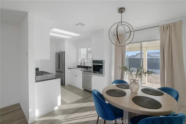 a kitchen with stainless steel appliances granite countertop a sink and cabinets