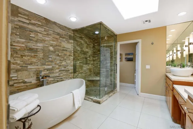 a en suite bathroom with a double vanity sink a mirror and a