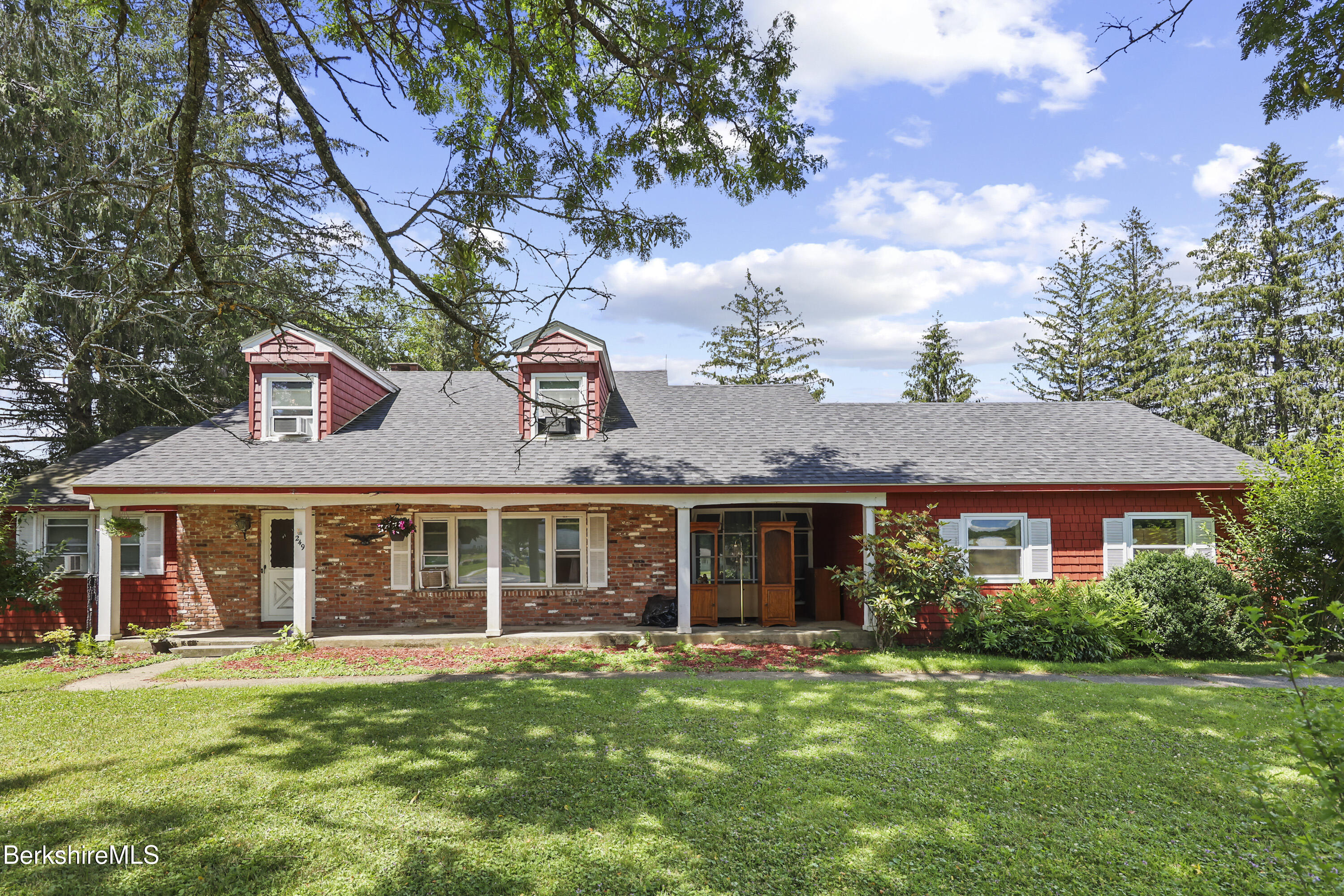 a front view of a house with a garden