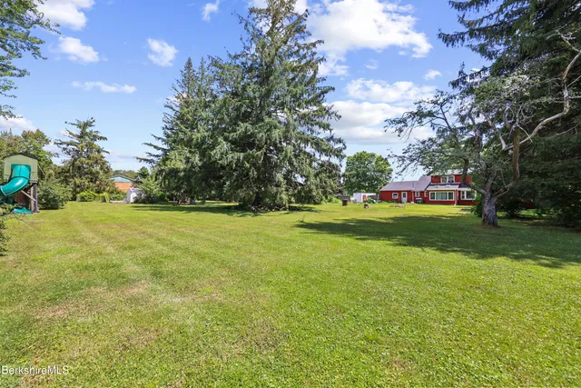 a view of swimming pool is middle in the garden