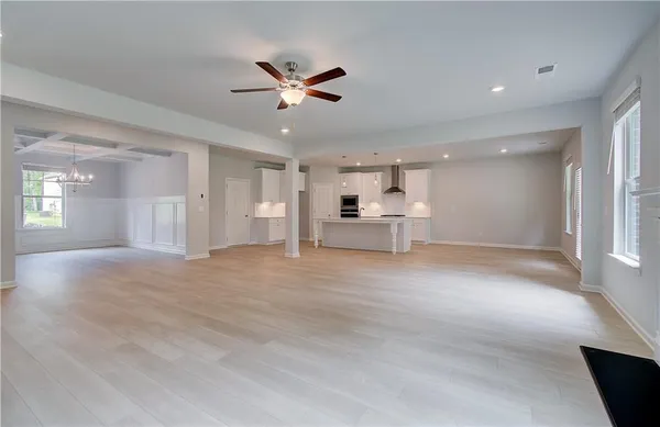 a view of empty room with wooden floor and window