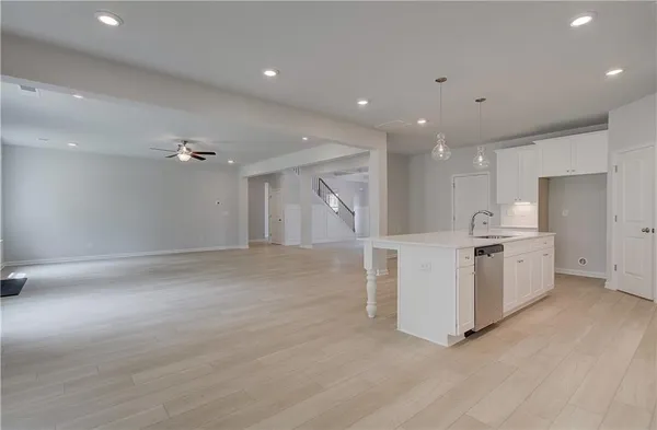 a view of a kitchen with refrigerator and white cabinets