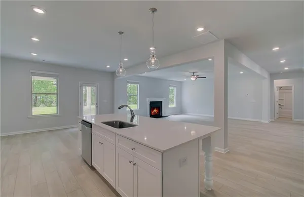 a kitchen with sink and mirror