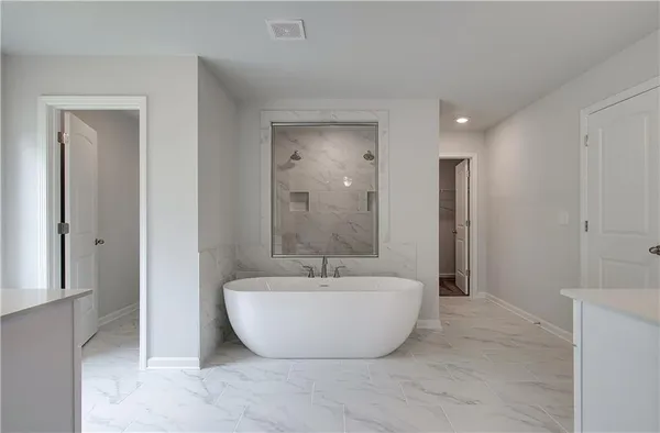 a spacious bathroom with a granite countertop sink a mirror and a