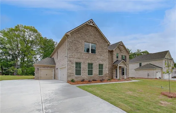 a front view of house with yard and green space