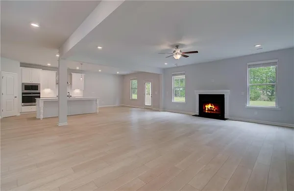 a view of an empty room with a fireplace and a window