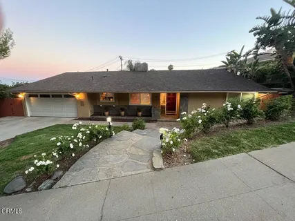 a view of a car park in front of house