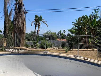 a view of a yard with large trees