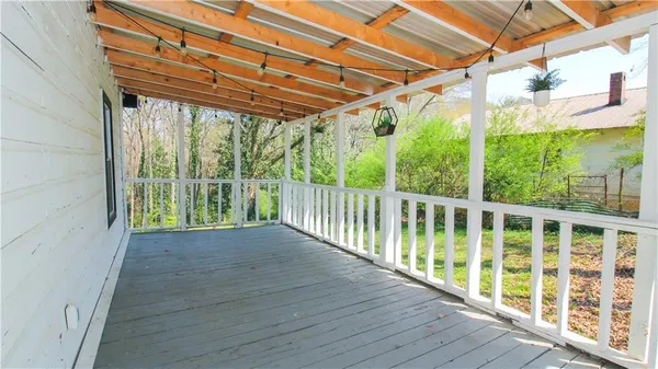 a view of a porch with wooden floor and outdoor space