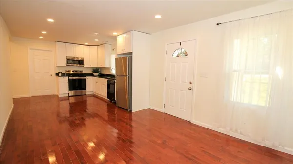 a kitchen with a refrigerator and a stove top oven