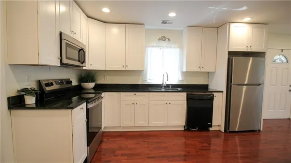 a kitchen with a refrigerator and a sink