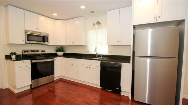 a kitchen with a refrigerator stove and microwave