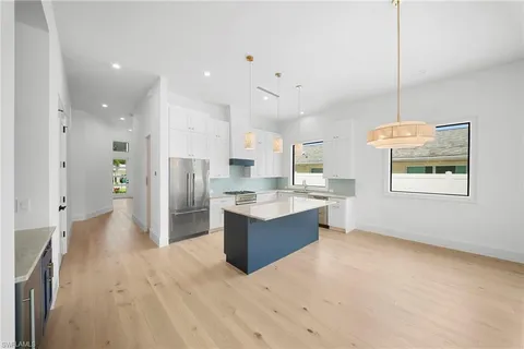 a large kitchen with a large counter top appliances and cabinets