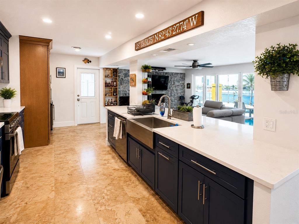 5431 Foley Square New Port Richey, FL 34652 - Photo 13 of 39 a kitchen with kitchen island a sink appliances and cabinets