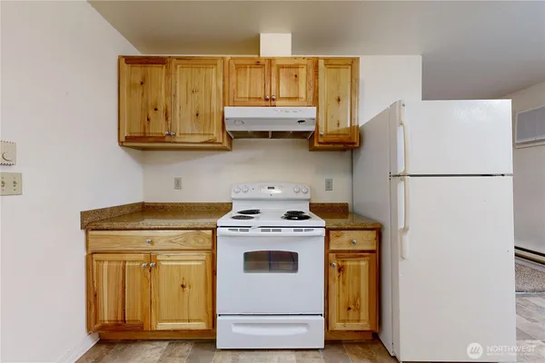 a kitchen with a stove top oven a sink and a refrigerator