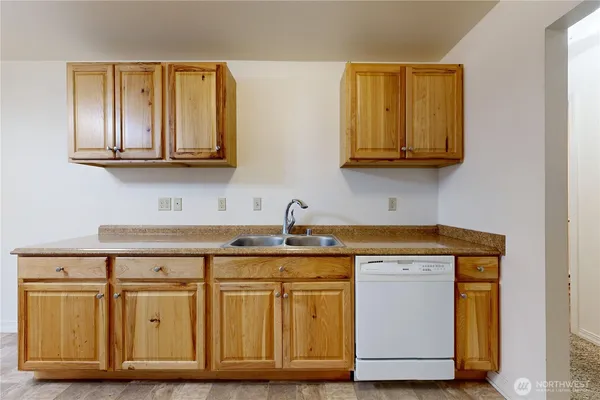 a kitchen with stainless steel appliances granite countertop a sink and cabinets