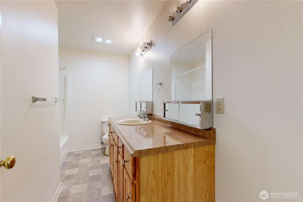 a bathroom with a sink a vanity and a mirror