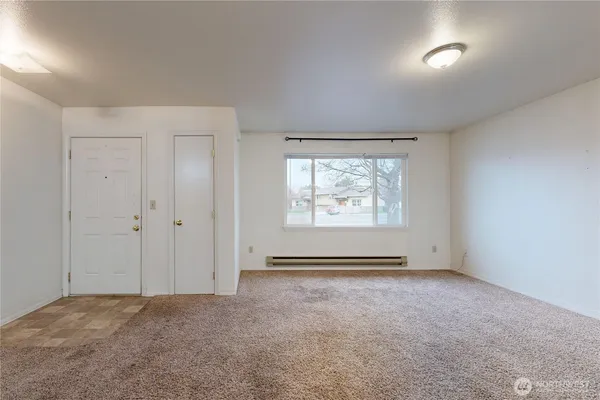 a view of an empty room with a window