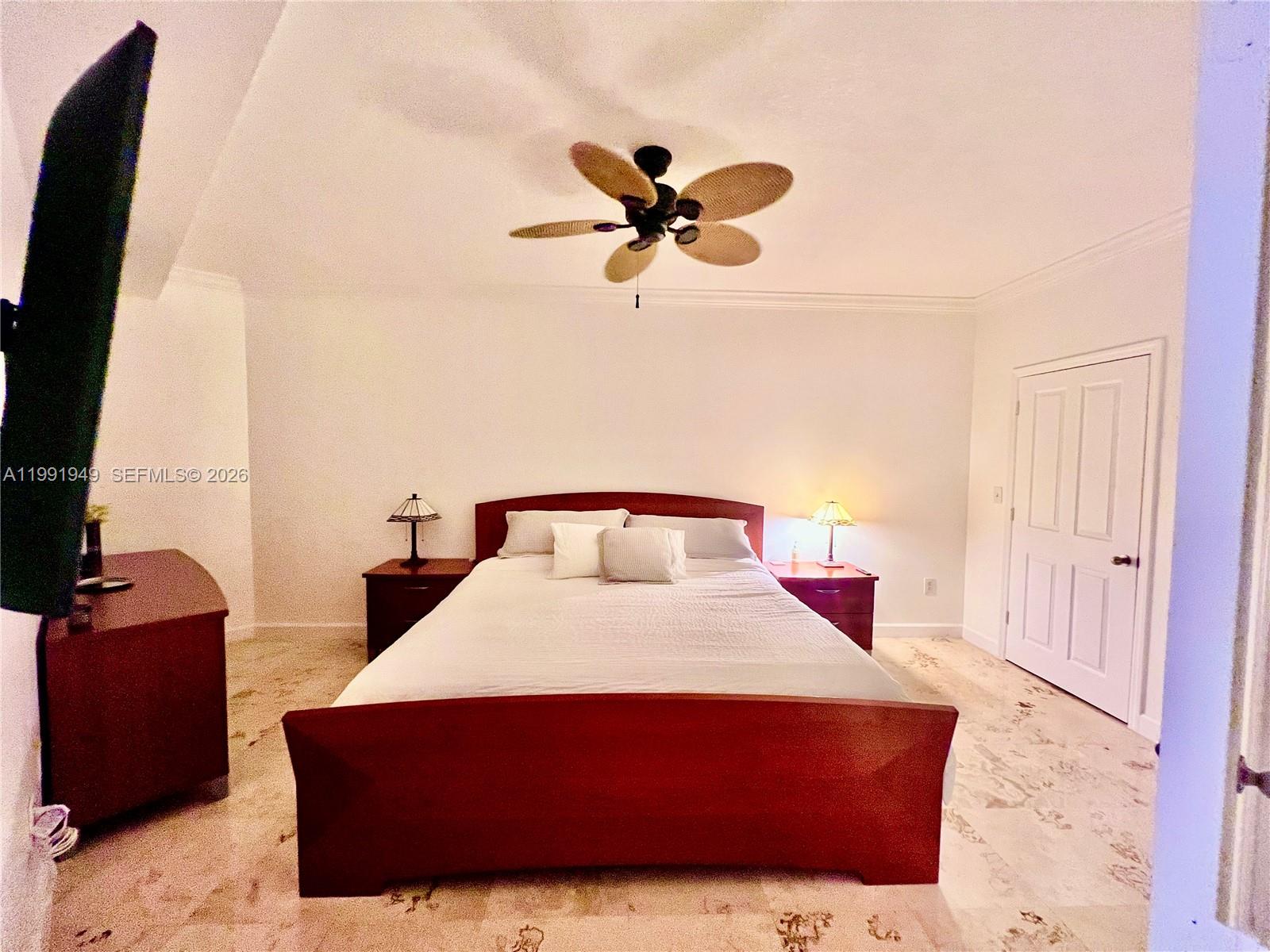 9172 Collins Avenue, Unit 305 Surfside, FL 33154 - Photo 12 of 37 a bedroom with a bed and wooden floor