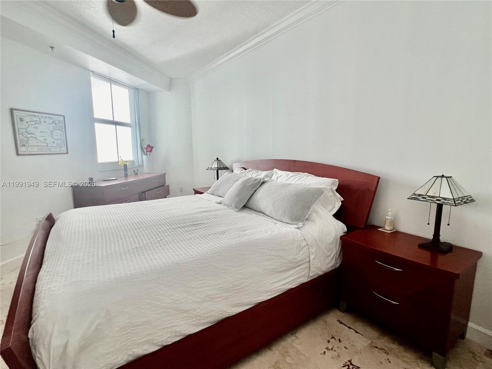 9172 Collins Avenue, Unit 305 Surfside, FL 33154 - Photo 13 of 37 a bedroom with a bed and window