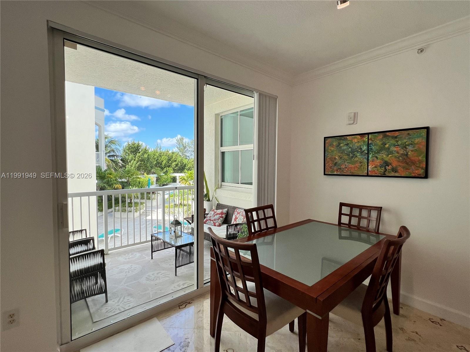 9172 Collins Avenue, Unit 305 Surfside, FL 33154 - Photo 16 of 37 a view of a dining room with furniture window and outside view