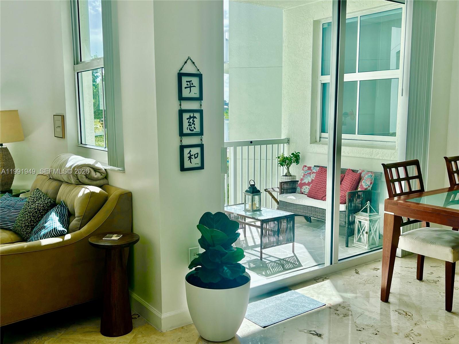 9172 Collins Avenue, Unit 305 Surfside, FL 33154 - Photo 17 of 37 a living room with furniture and a potted plant