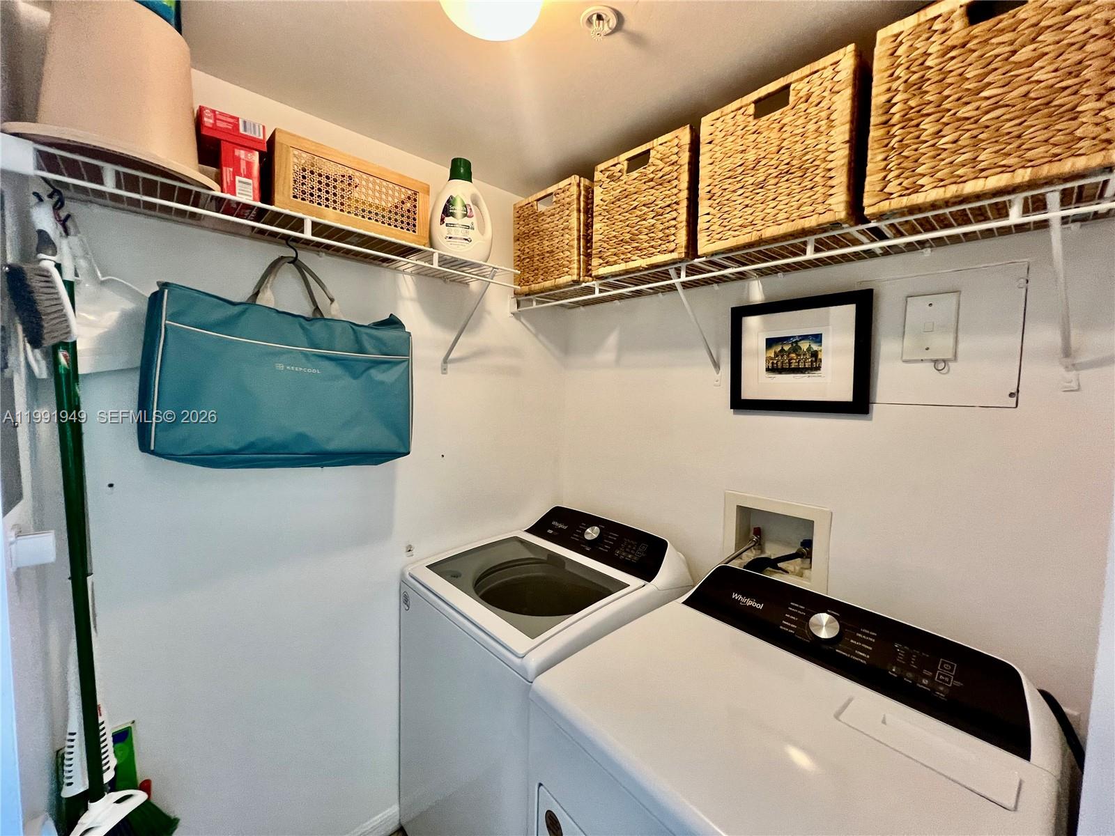 9172 Collins Avenue, Unit 305 Surfside, FL 33154 - Photo 18 of 37 a utility room with dryer and washer
