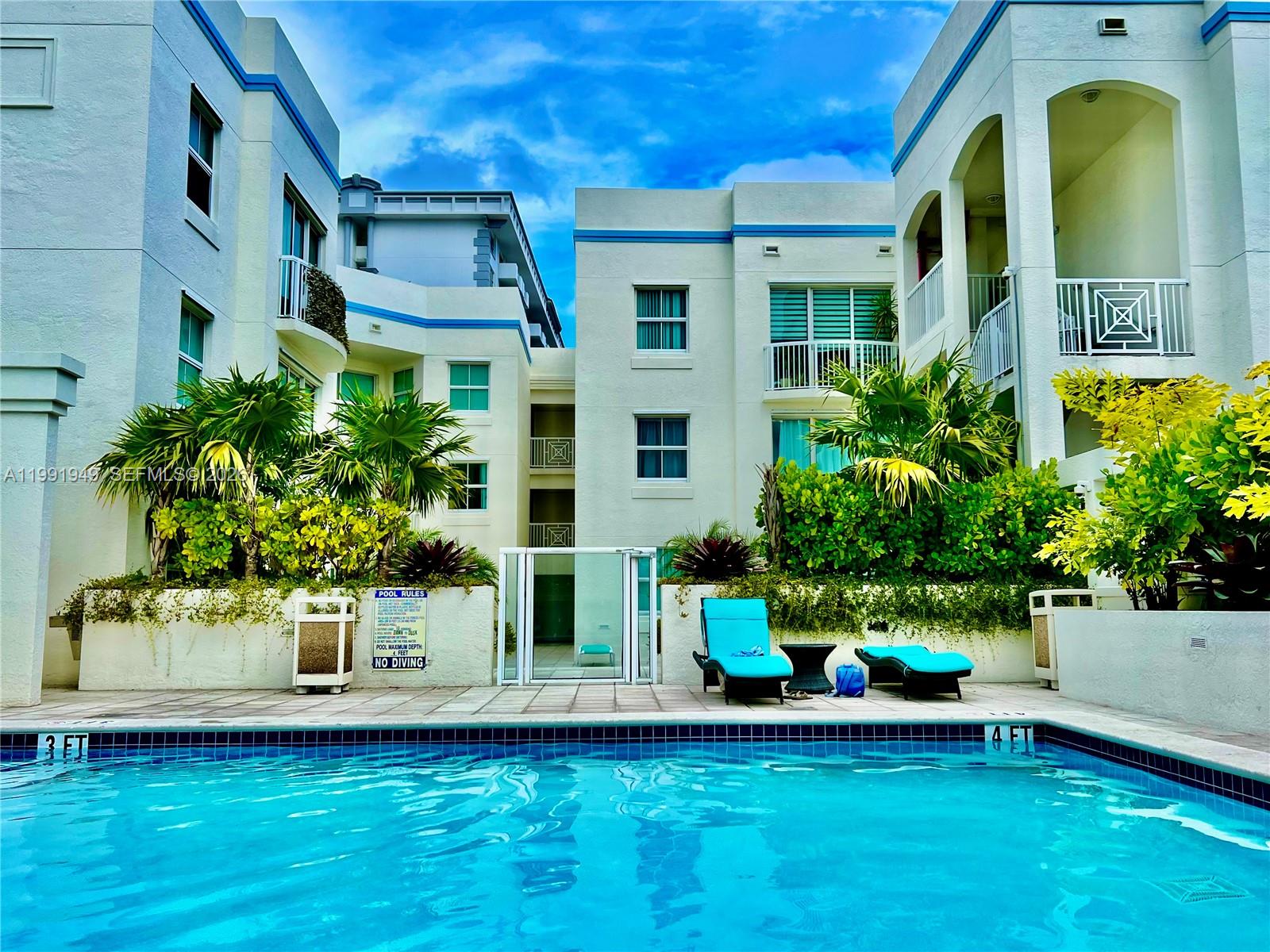 9172 Collins Avenue, Unit 305 Surfside, FL 33154 - Photo 19 of 37 a front view of a house with a yard