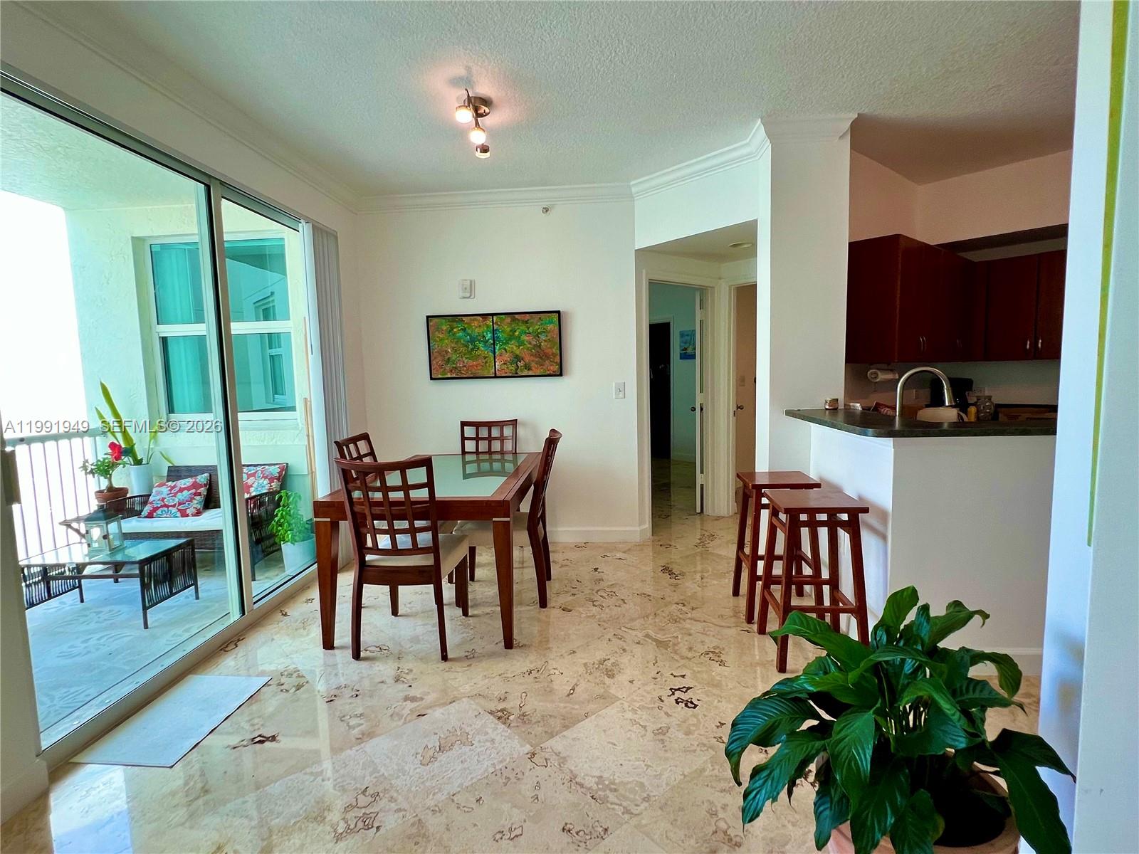 9172 Collins Avenue, Unit 305 Surfside, FL 33154 - Photo 2 of 37 a view of a dining room with furniture window and outside view
