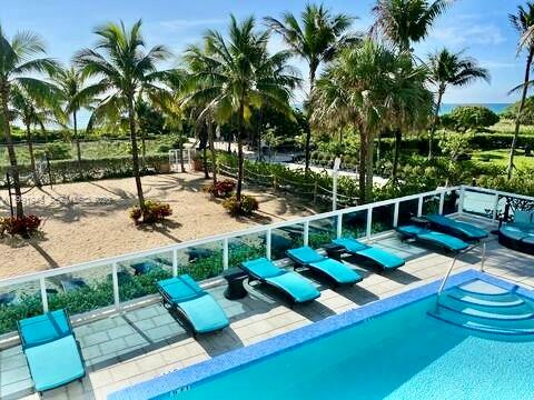 9172 Collins Avenue, Unit 305 Surfside, FL 33154 - Photo 21 of 37 a view of a house with swimming pool