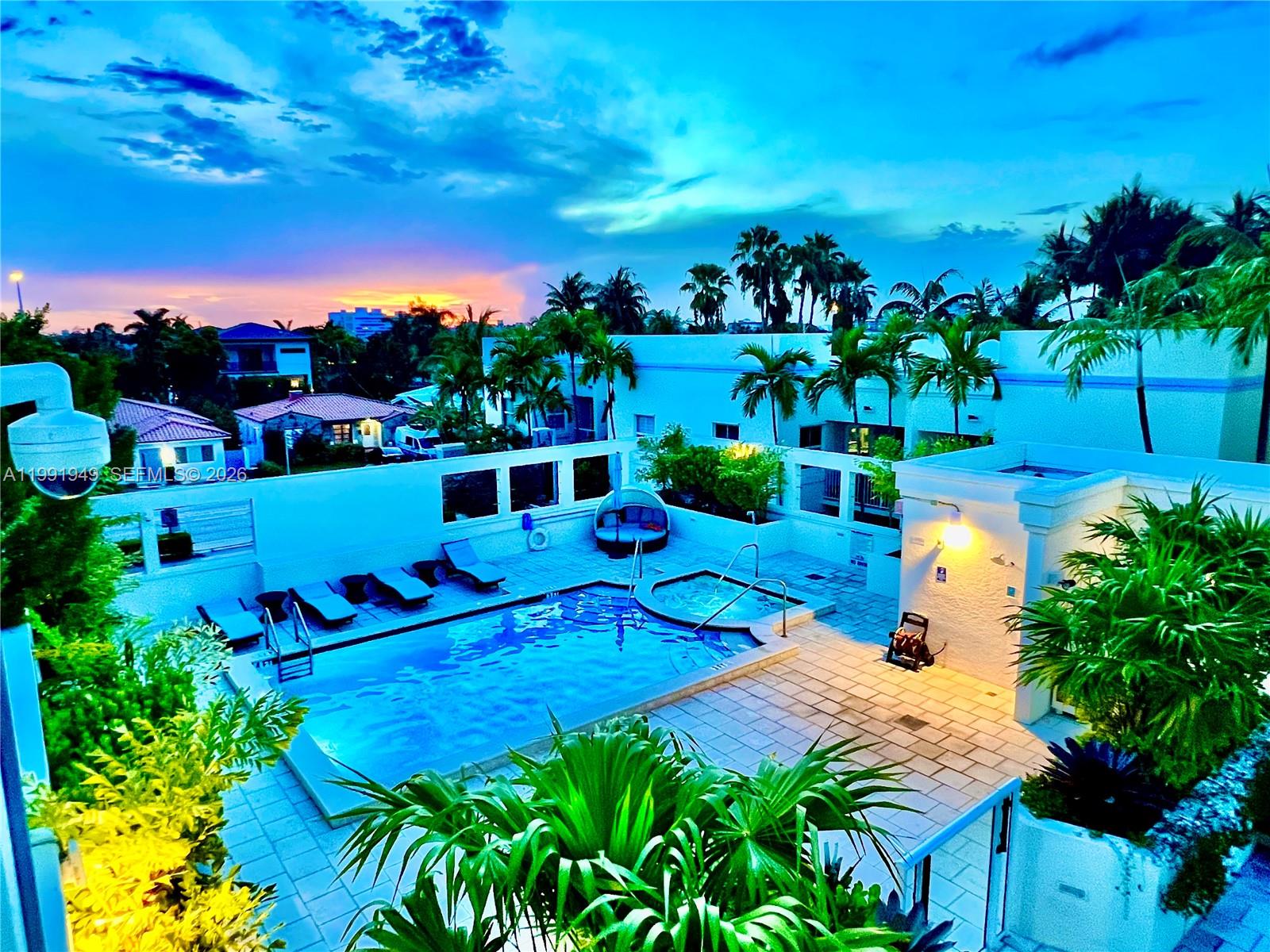 9172 Collins Avenue, Unit 305 Surfside, FL 33154 - Photo 32 of 37 a view of a swimming pool with outdoor seating