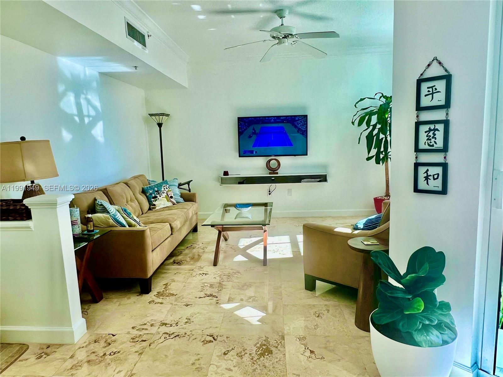 9172 Collins Avenue, Unit 305 Surfside, FL 33154 - Photo 5 of 37 a living room with furniture