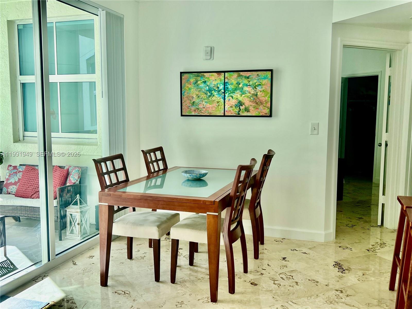 9172 Collins Avenue, Unit 305 Surfside, FL 33154 - Photo 6 of 37 a dining room with furniture and window
